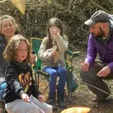 A family enjoying an activity at the forest school